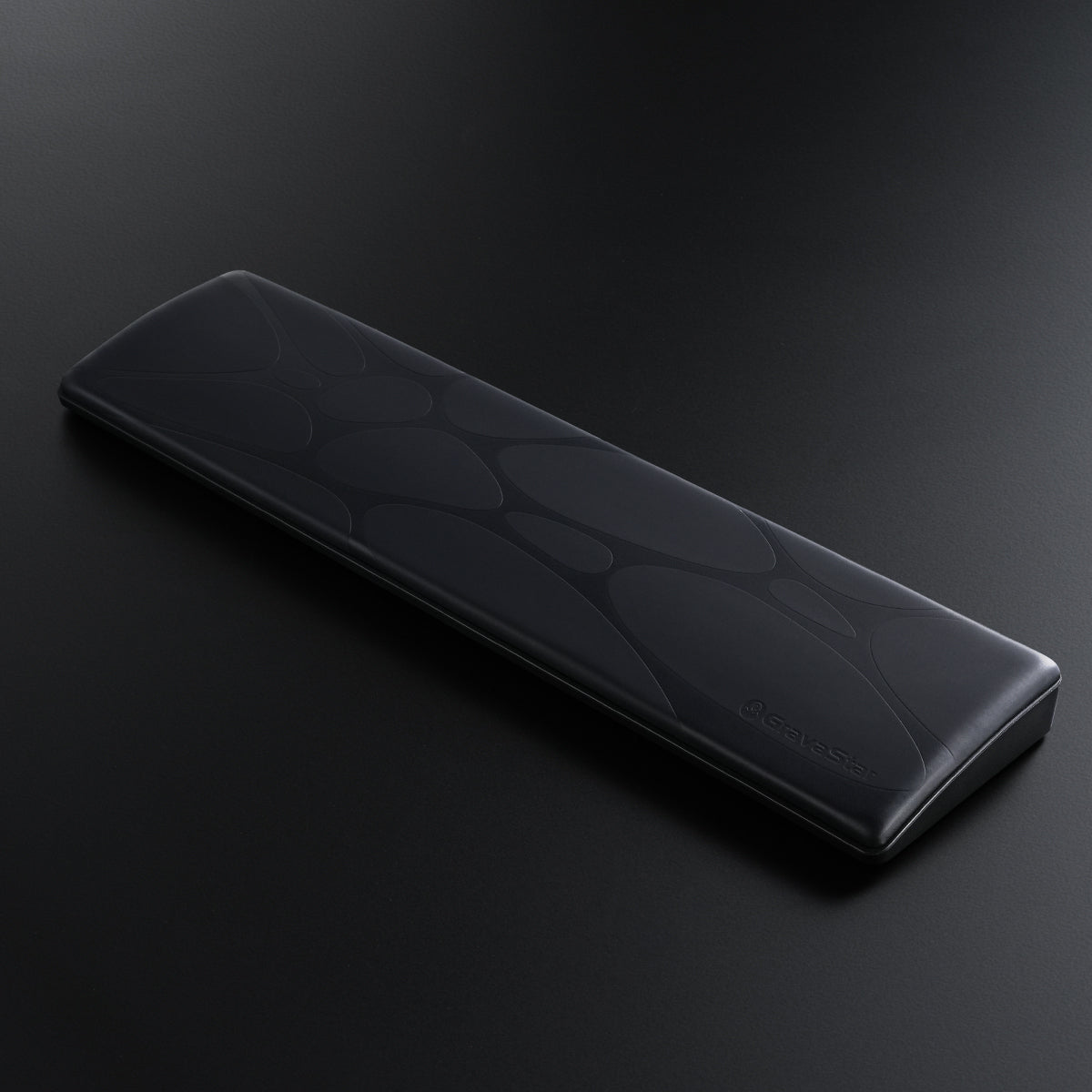 GravaStar 60% Keyboard Wrist Rest Pad Black studio 3d diagonal perspective view featuring ergonomic PU leather surface, embossed GravaStar logo, non-slip ABS base, and compact wrist alignment support, perfect paired with Mercury V60 Pro Black keyboard and Mercury M1 Pro Gunmetal Gray gaming mouse.