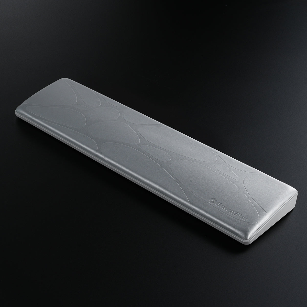 GravaStar 60% Keyboard Wrist Rest Pad Silver studio 3d diagonal perspective view featuring ergonomic PU leather surface, embossed GravaStar logo, non-slip ABS base, and compact wrist alignment support, perfect paired with Mercury V60 Pro keyboard and Mercury M1 Pro Silver Mist gaming mouse.