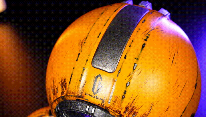 GravaStar Mars Pro Special Edition War-Damaged Yellow handcrafted Bluetooth speaker animated GIF demonstrating top touch-sensitive panel for volume adjustment with glowing LED indicators, powered by battle-worn finish, zinc alloy shell, 20-watt dual speaker system, and ice blue RGB lighting.