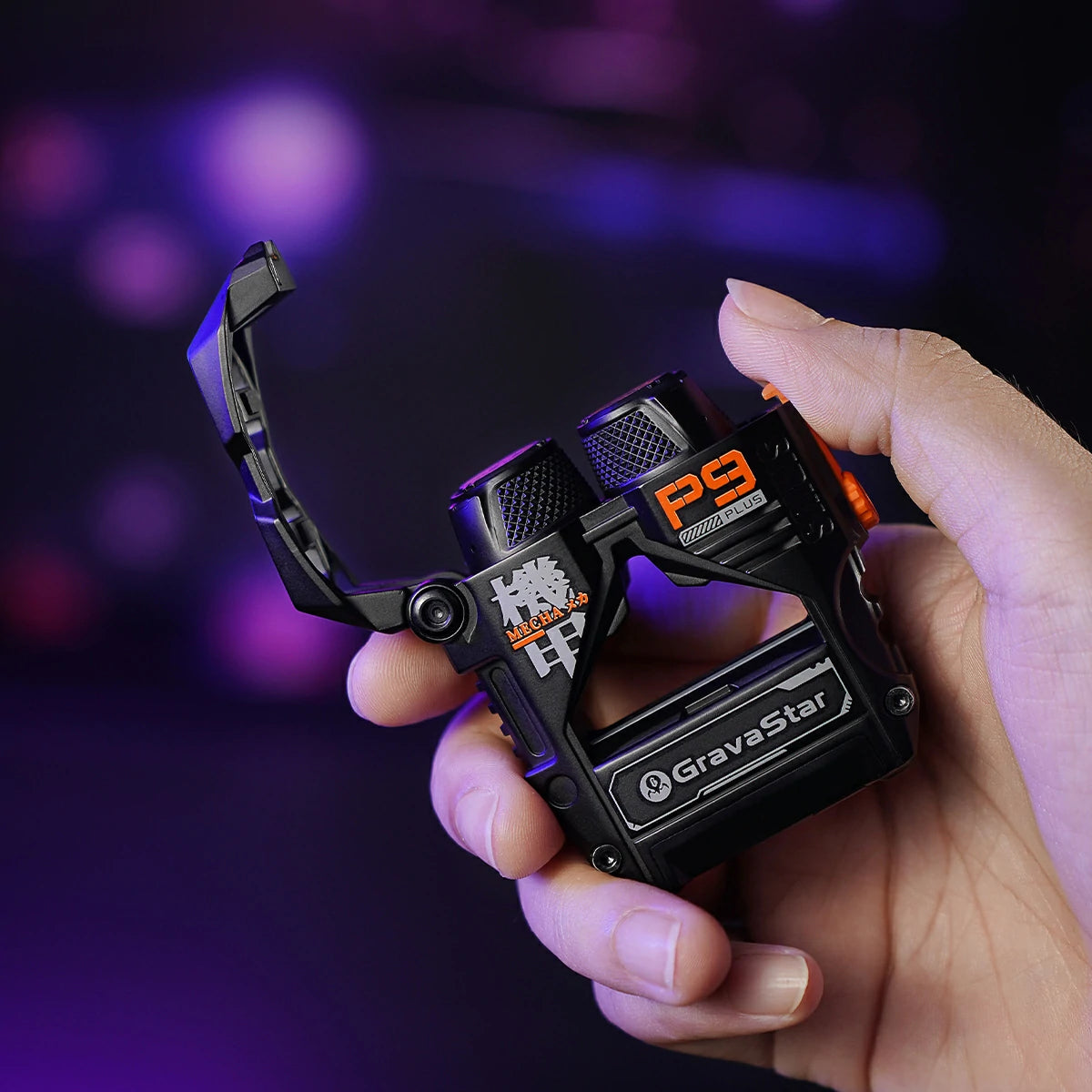 GravaStar Sirius Plus Black wireless ANC earbuds held in hand showing open matte black zinc aluminium alloy mecha charging case with integrated bottle opener structure and mecha graphics.