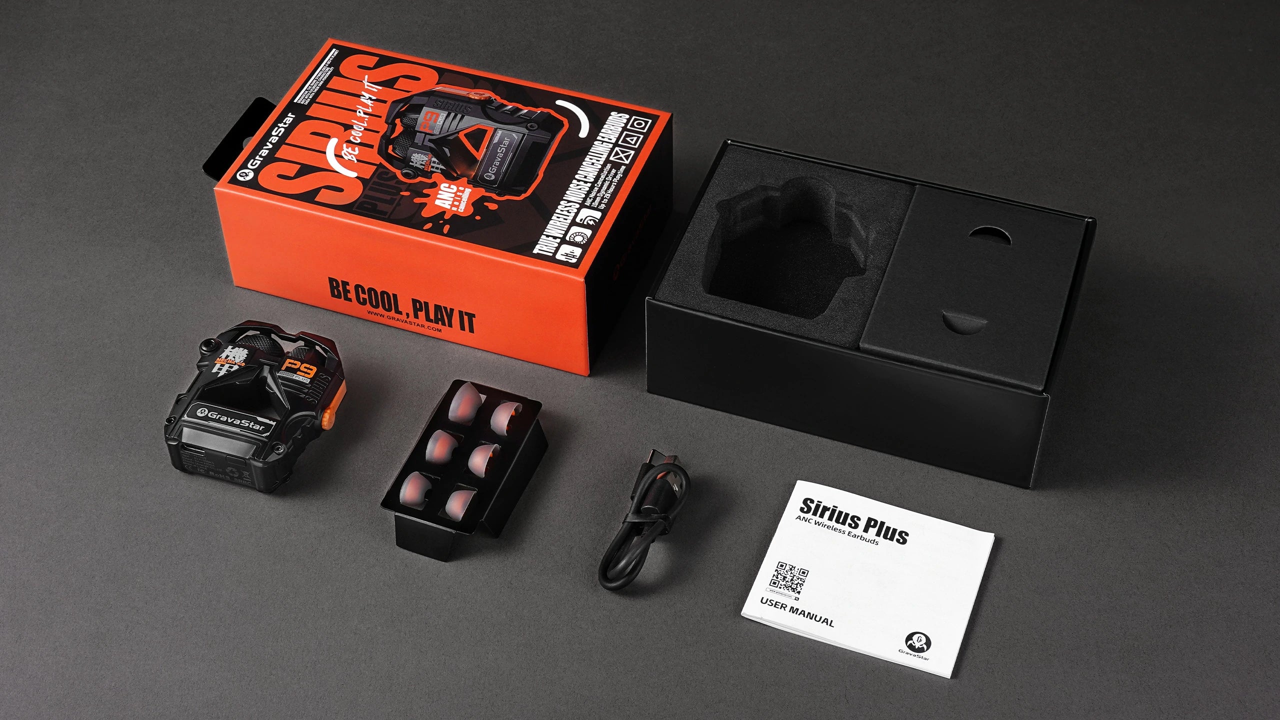 GravaStar Sirius Plus Black wireless ANC earbuds full packaging and accessories set including matte black zinc aluminium alloy charging case, 3 replacement earbud tip pairs, USB-C charging cable, and user manual.