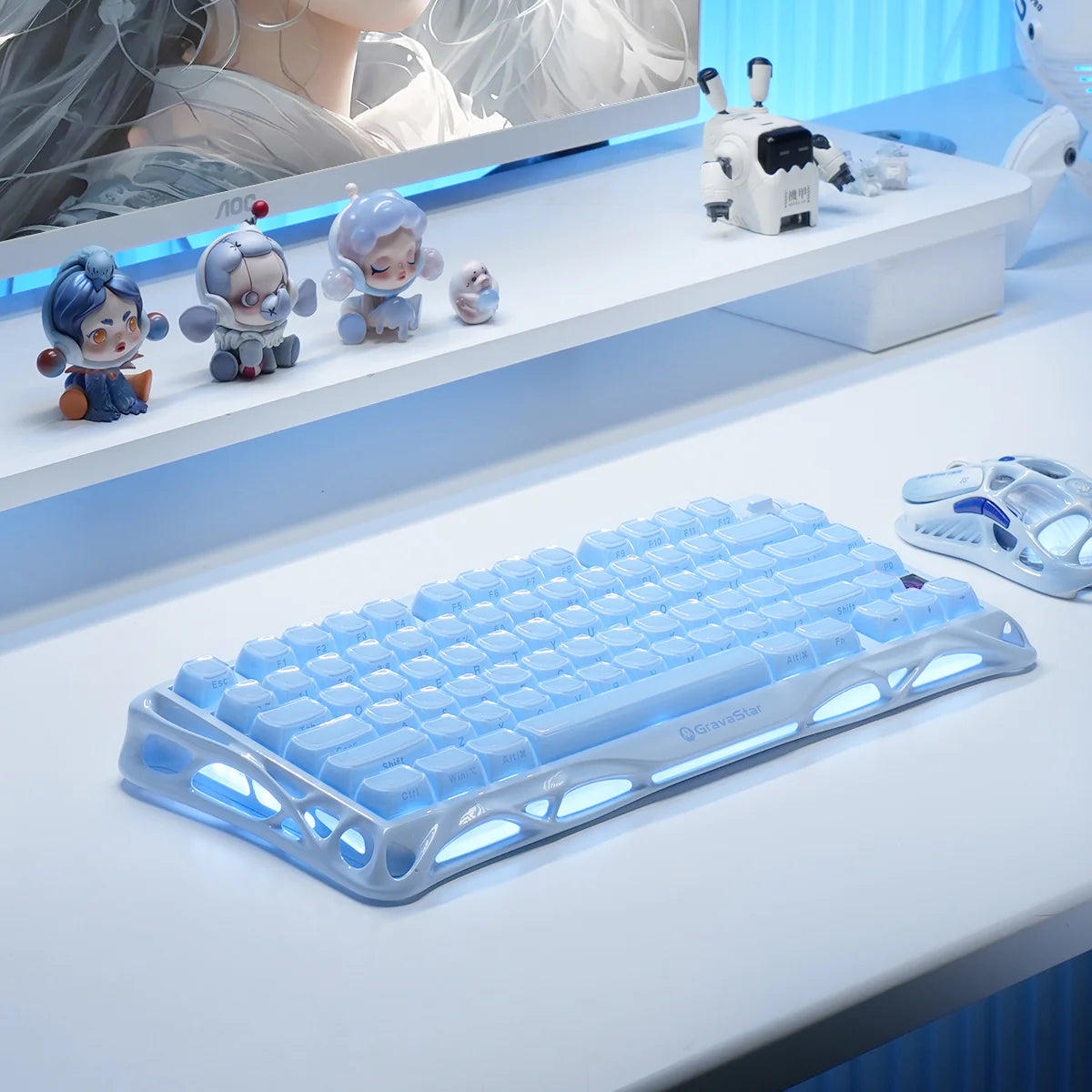 GravaStar Mercury K1 Ice Blue Edition 75% mechanical gaming keyboard featured in an anime ice-blue desk setup alongside the Mercury M1 Pro Ice Blue wireless gaming mouse, white monitor stand, and dual independent RGB lighting.