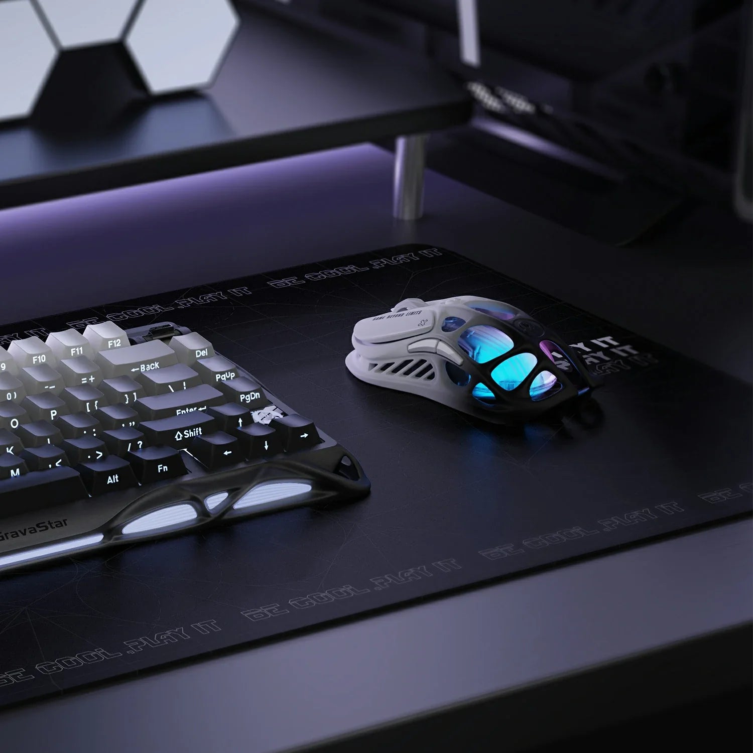 GravaStar Mercury M1 Pro Gradient Black wireless gaming mouse shown on desk setup with Mercury K1 Pro keyboard – Highlighting magnesium alloy skeletal frame, PAW3395 26K DPI sensor, Omron 50M micro-switches, 4KHz polling rate ready, and customizable RGB lighting.