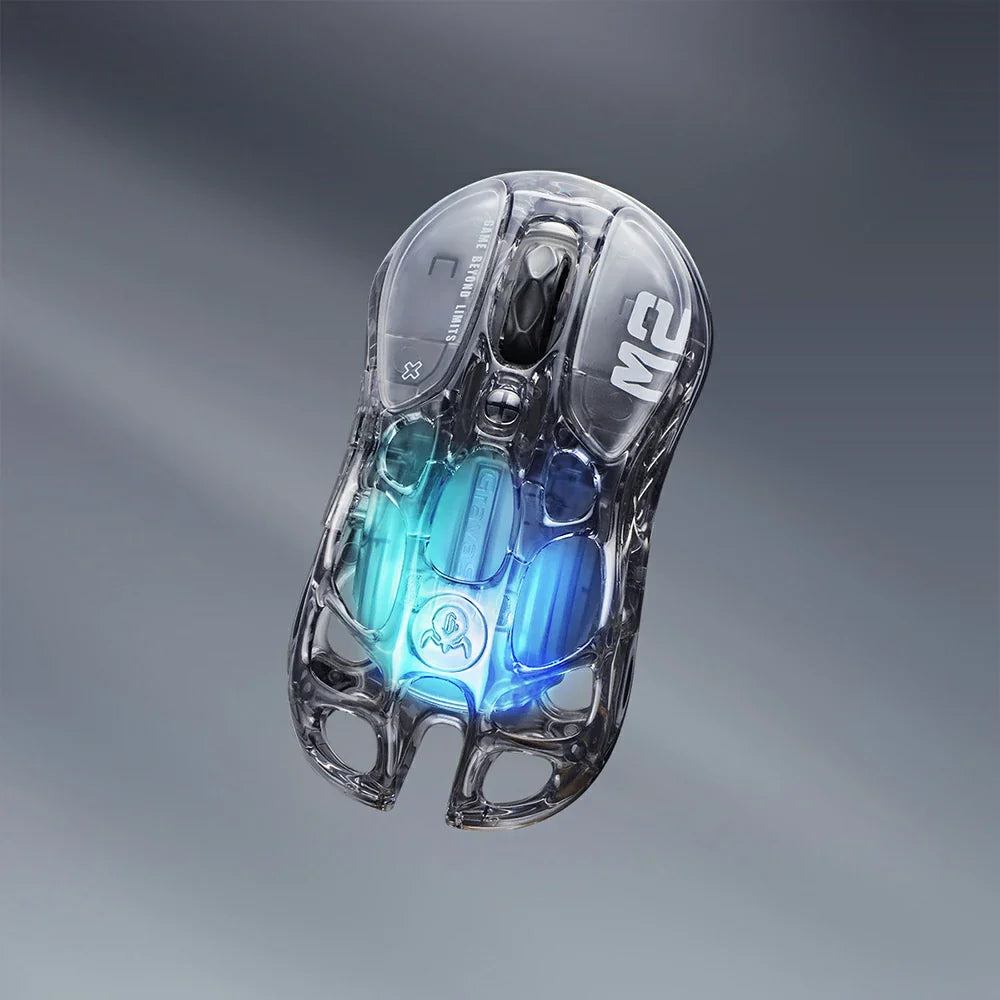 GravaStar Mercury M2 Transparent Black wireless gaming mouse top vertical view – Highlighting see-through crystal housing, skeletal frame design, PAW3395 26K DPI sensor, Kailh 80M micro-switches, and blue RGB lighting, perfect paired with Mercury K1 Lite Transparent Black keyboard and Mars Pro Black speaker.