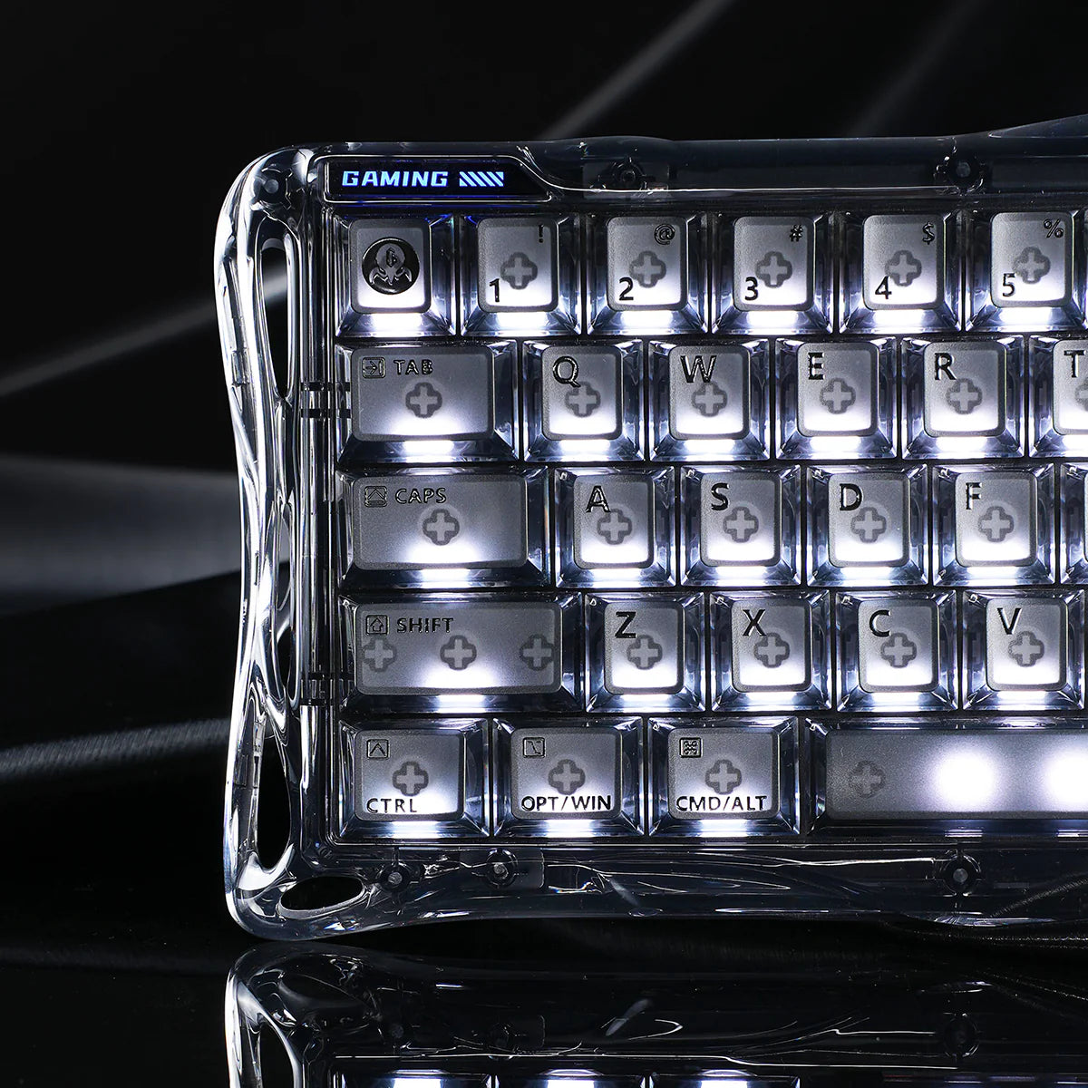 GravaStar Mercury V60 Onyx Crystal 60% transparent magnetic gaming keyboard left macro view – Showcasing transparent PC housing, GAMING tactical decal, translucent keycaps, and dynamic RGB lighting reflection.