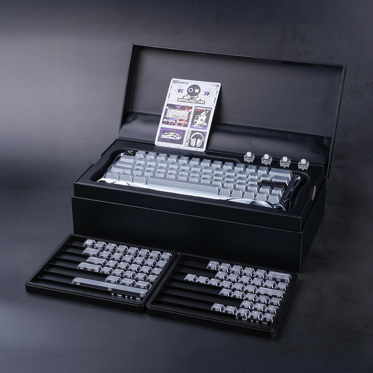 GravaStar Mercury V60 Pro Deluxe Edition – Dual Keycap Gift Box Set - Interior view of the open luxury gift box showcasing the 8kHz magnetic gaming keyboard and lower tray with the bonus full frosted PC keycaps set and extra switches for FPS esports.