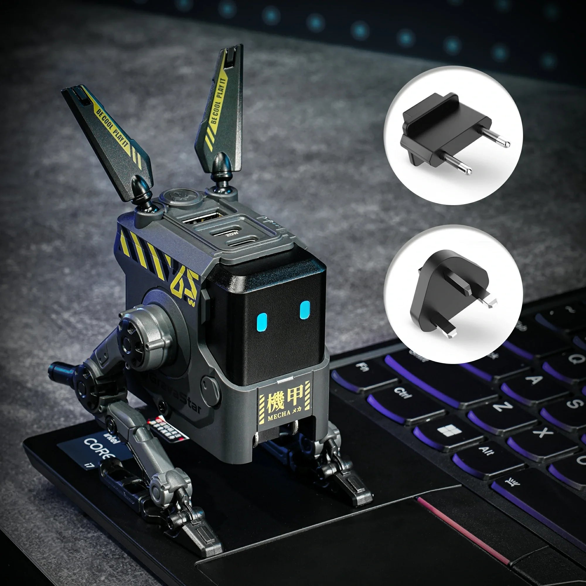 GravaStar Alpha65 GaN 65W Wall Charger Charcoal Gray studio setup view showcasing transformable mecha robot body, ice blue RGB eyes, and detachable UK and EU plug adapters for universal voltage support.