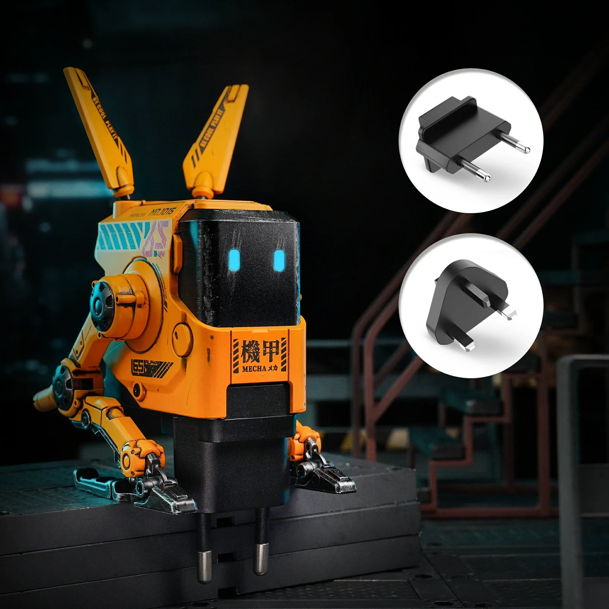 GravaStar Alpha65 GaN 65W Wall Charger War-Damaged Yellow studio setup view showcasing handcrafted weathered yellow robot body, ice blue RGB eyes, and detachable UK and EU plug adapters for universal voltage support.