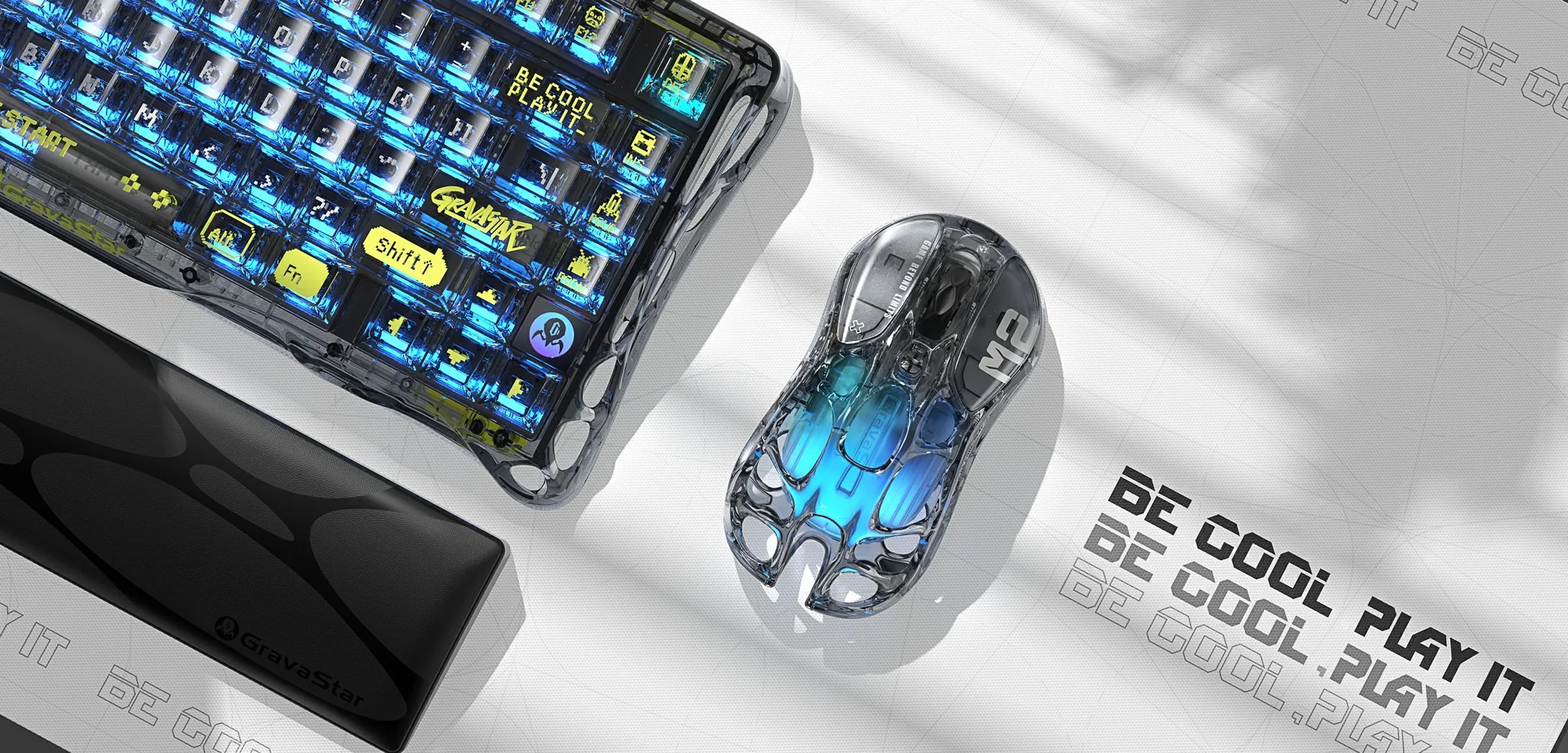 GravaStar Core Flex Gaming Set Transparent Black desk setup view featuring Mercury K1 Lite 75% wireless mechanical keyboard with RGB lighting, Mercury M2 gaming mouse, and keyboard wrist rest pad.