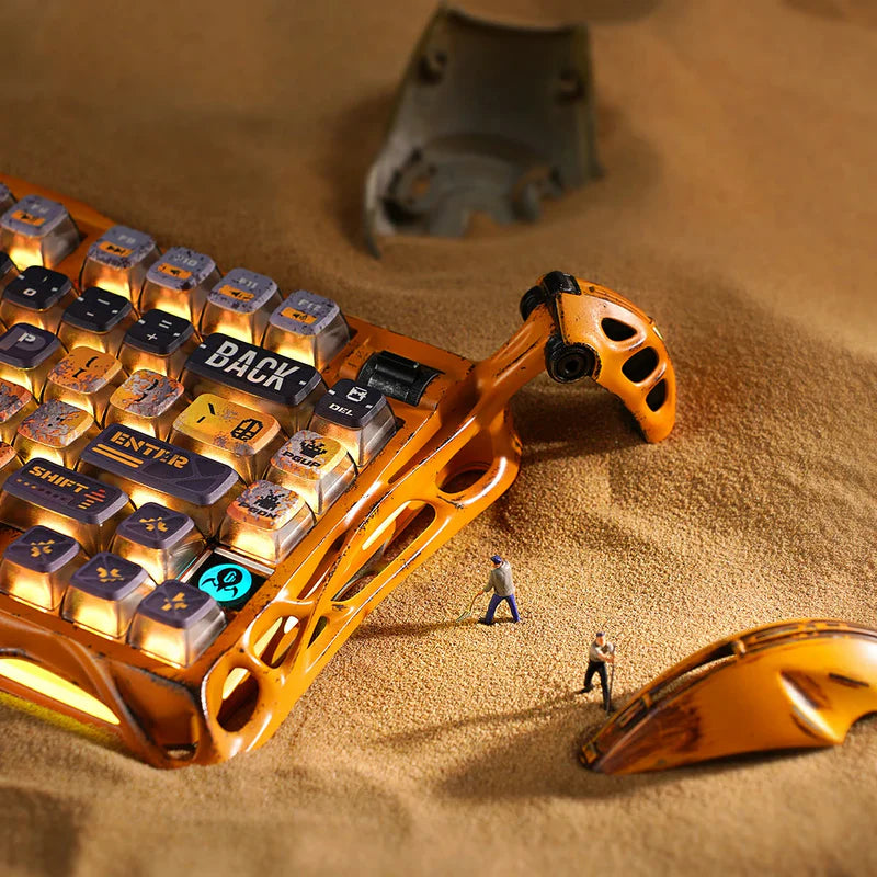 GravaStar Mercury K1 Pro Special Edition Battle-Worn Yellow wireless mechanical keyboard set in desert scene featuring 100% handcrafted weathered aluminum frame, Kailh Speedy Mint linear switches, Pudding PBT keycaps, gasket-mounted dampening design, and Mercury X Pro 8KHz magnesium alloy gaming mouse.
