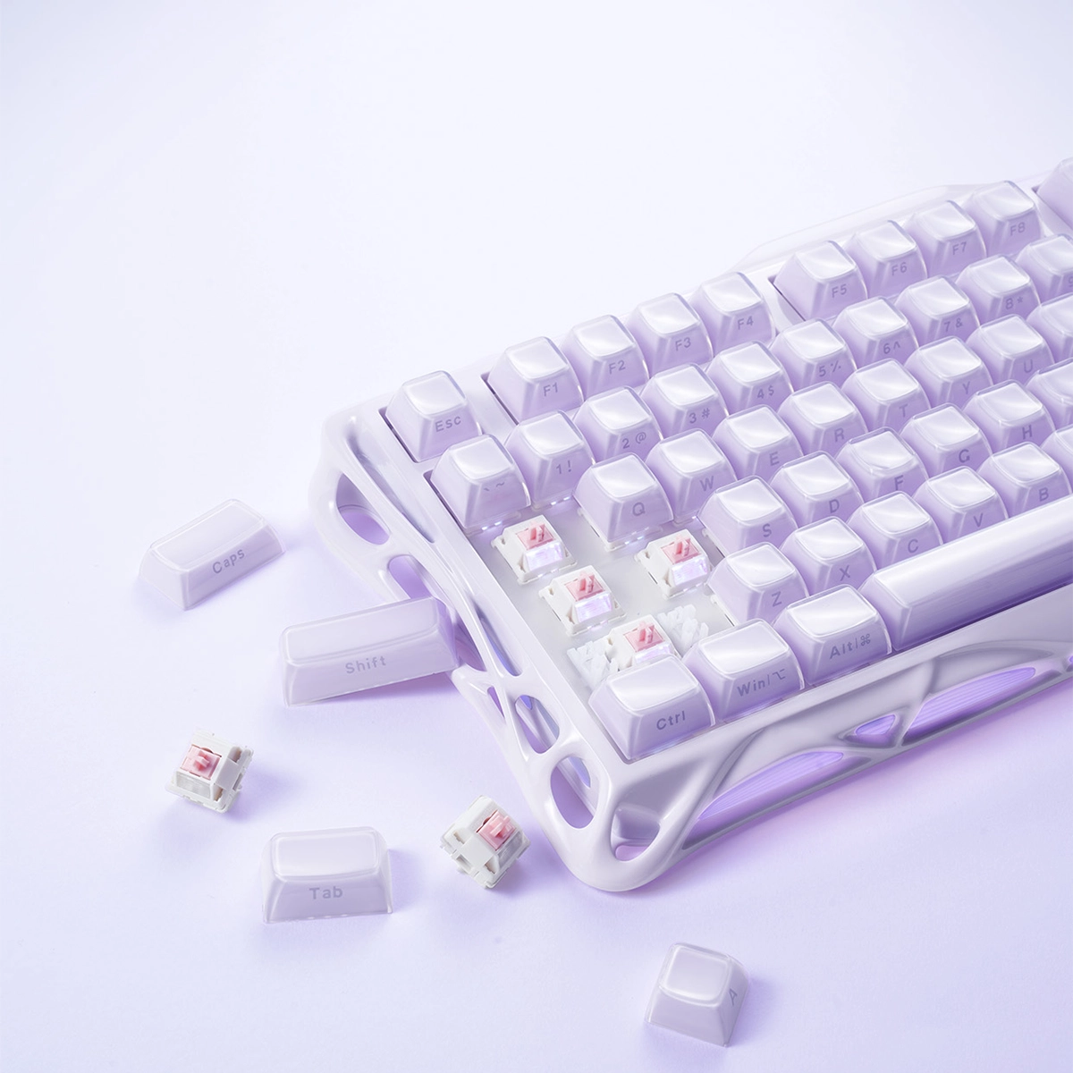 GravaStar Mercury K1 Special Edition Lavender Purple 75% mechanical gaming keyboard close-up with scattered PBT keycaps highlighting metallic purple aluminum alloy chassis, custom linear switches, and hot-swap PCB architecture.