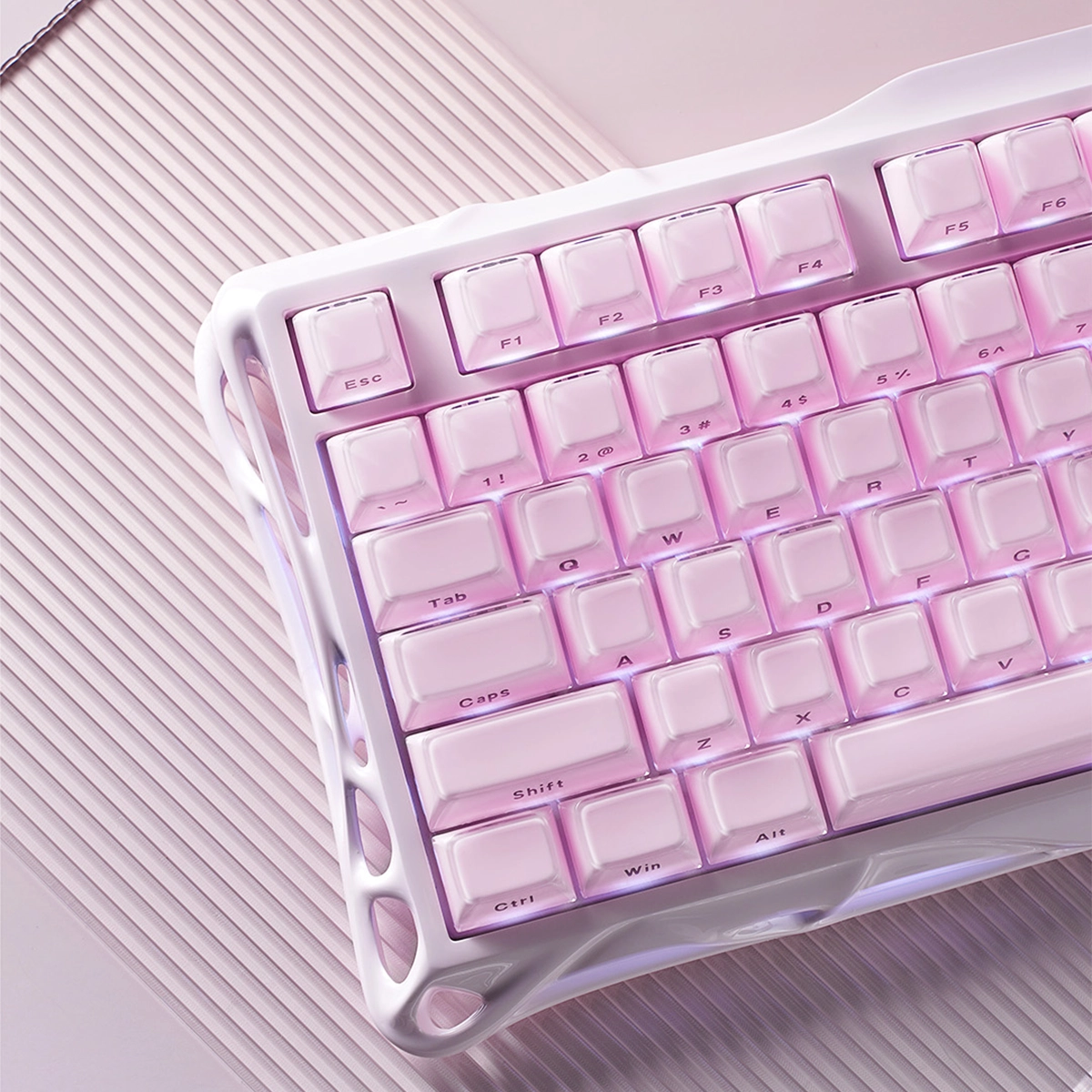 GravaStar Mercury K1 Special Edition Sakura Pink 75% mechanical gaming keyboard close-up showing pink aluminum alloy chassis, gradient PBT keycaps, custom linear switches, and ARGB backlighting.