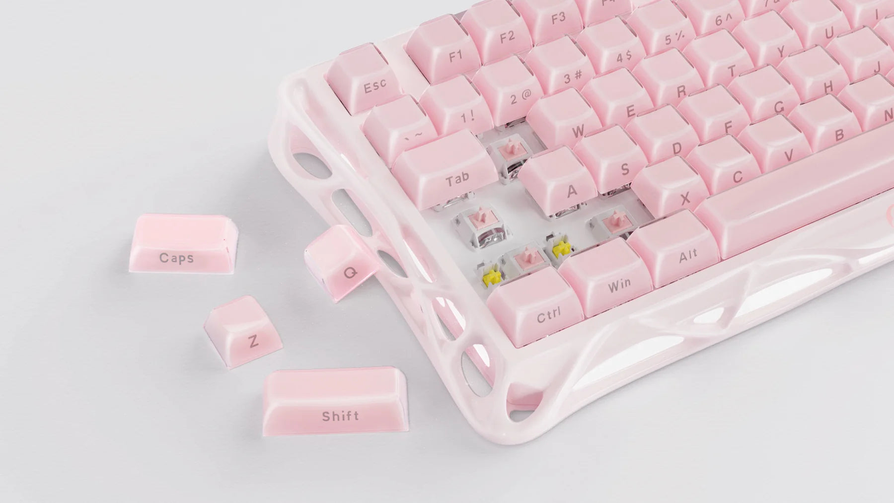 GravaStar Mercury K1 Special Edition Sakura Pink 75% mechanical gaming keyboard close-up with scattered PBT keycaps highlighting pink aluminum alloy chassis, custom linear switches, and hot-swap PCB architecture.
