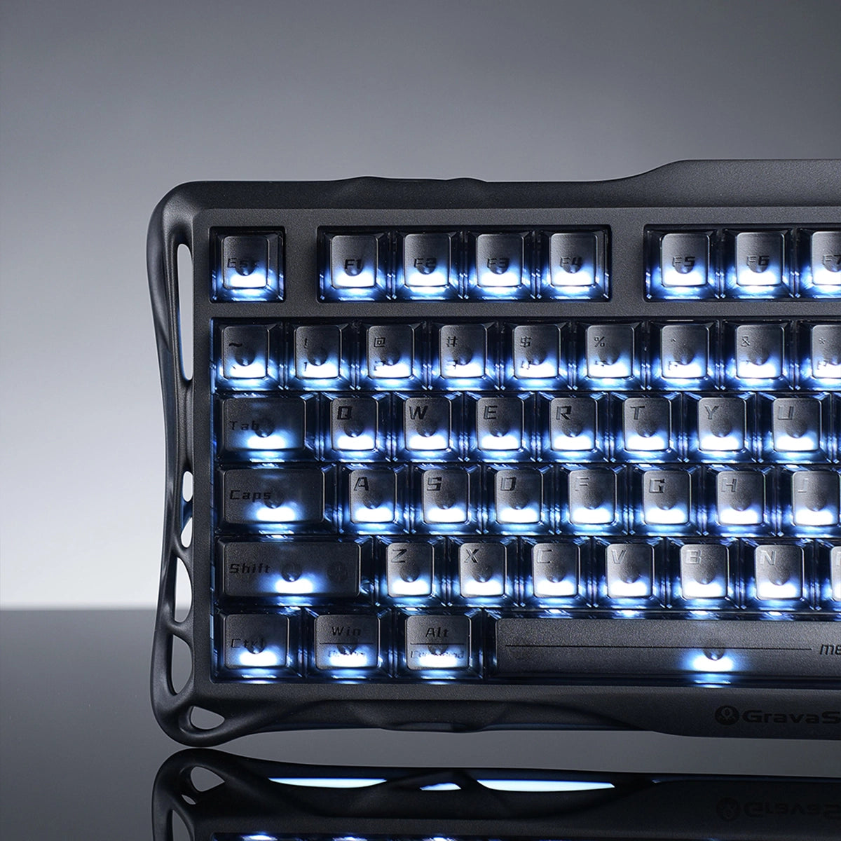 GravaStar Mercury K1 Stealth Black 75% wireless mechanical gaming keyboard close-up showcasing matte black aluminum alloy exoskeleton frame, engraved GravaStar logo, translucent PBT keycaps, and dual-zone RGB backlighting.