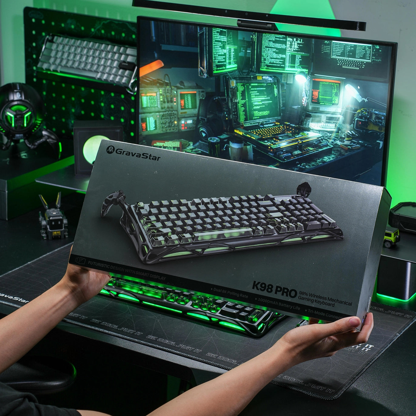 GravaStar Mercury K98 Pro Phantom Black 98% mechanical gaming keyboard premium unboxing packaging box showcase highlighting tactical artwork and glossy aluminum alloy exoskeleton keyboard on cyber gaming setup desk.