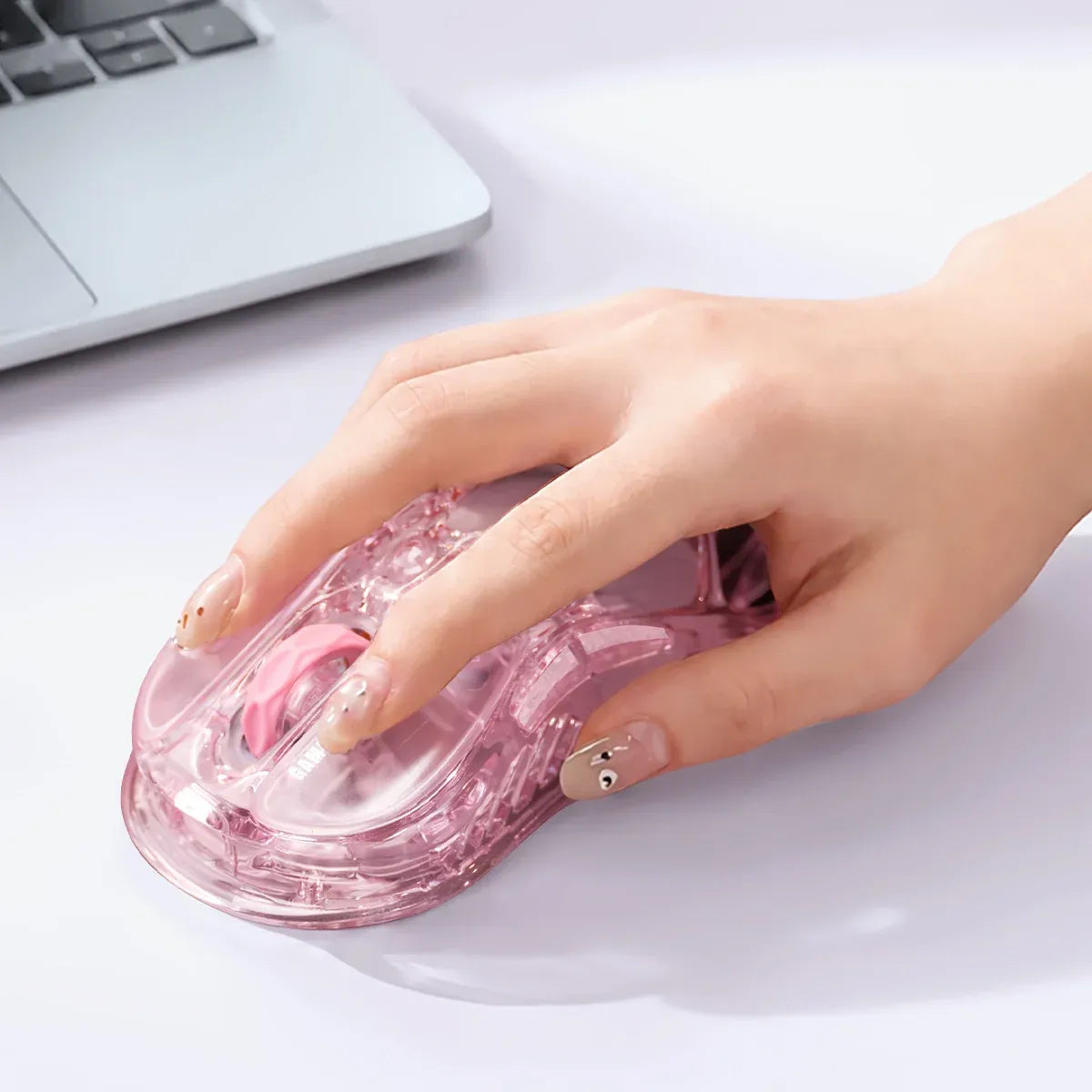 GravaStar Mercury M2 Crystal Rose translucent wireless gaming mouse in-hand usage diagram demonstrating ergonomic grip comfort and ambidextrous shape compatibility, powered by 79g light skeletal frame and PAW3395 26K DPI optical sensor.