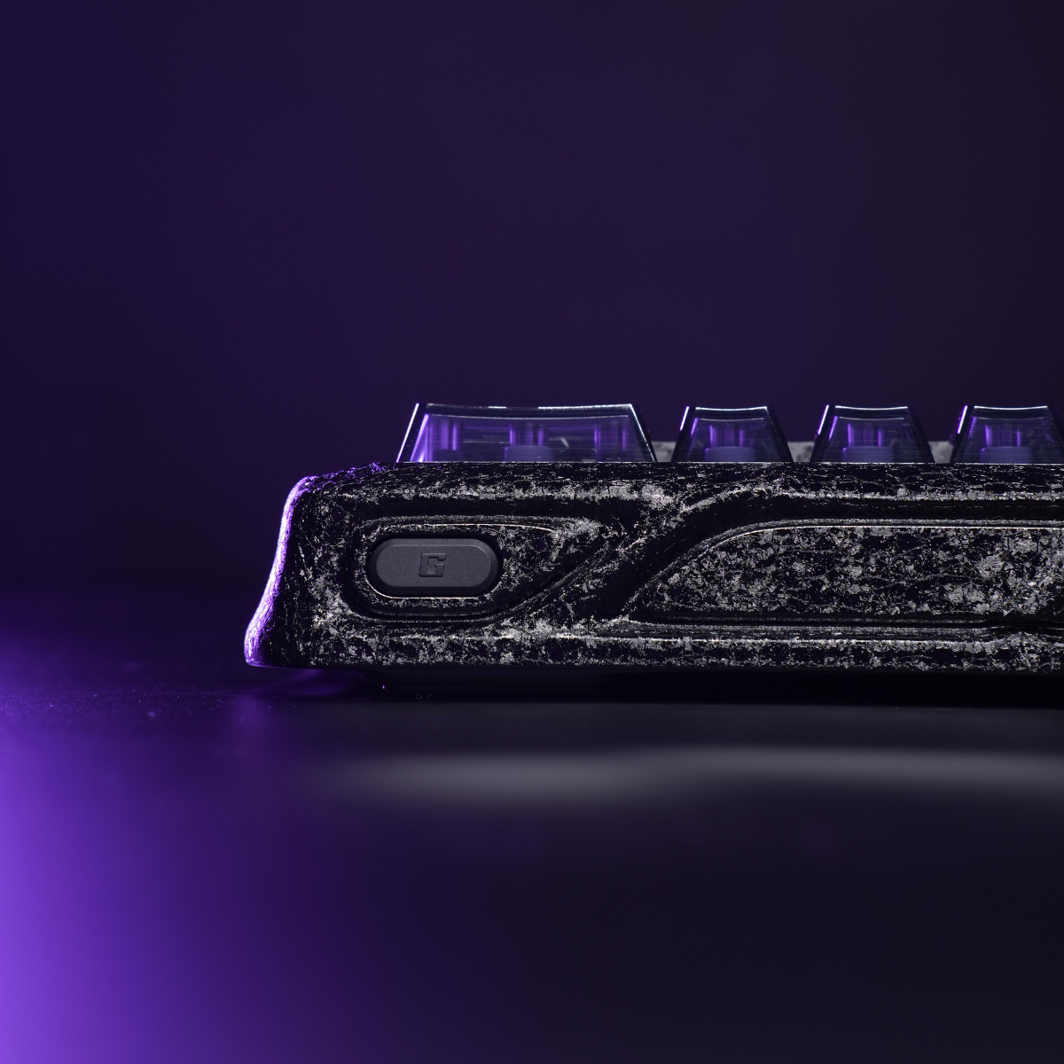 GravaStar Mercury V60 Pro Special Edition Cyber Frost Black 60% compact aluminum gaming keyboard side view featuring forged carbon texture chassis with metallic G logo, translucent keycaps, purple RGB lighting, True 8kHz polling rate, and 0.125ms low latency.