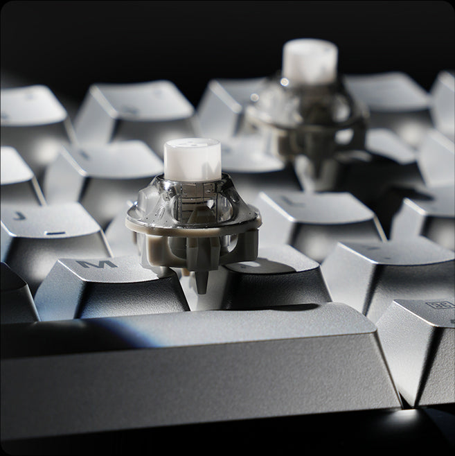 GravaStar Mercury V60 Pro Deluxe Edition Chrome Silver 60% compact aluminum gaming keyboard close-up displaying hot-swappable white UFO Hall Effect magnetic switch, True 8kHz polling rate, 0.125ms low latency, and 0.005mm Rapid Trigger precision.