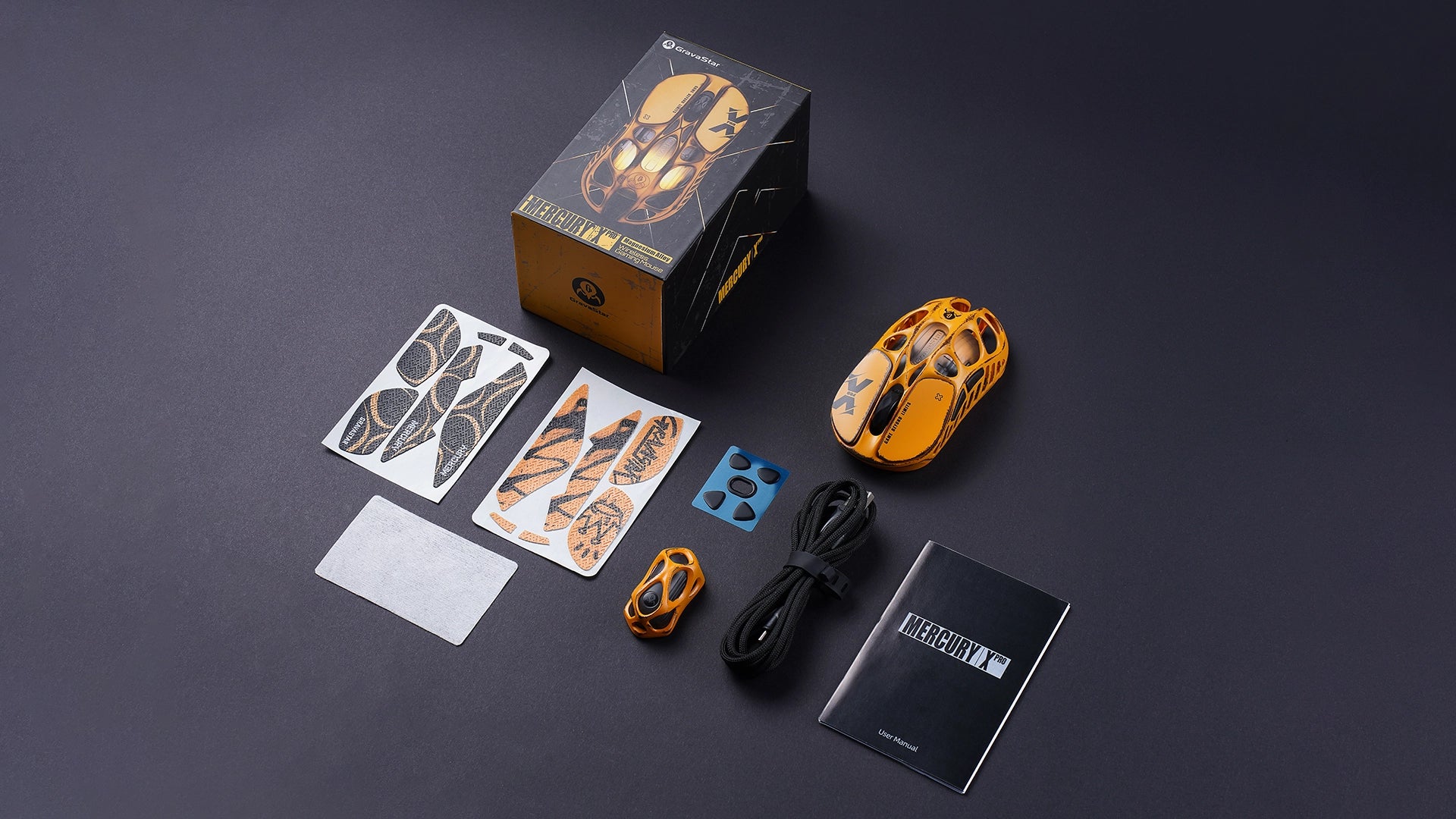 GravaStar Mercury X Pro Special Edition Battle Worn-Yellow magnesium alloy wireless gaming mouse unboxing layout showcasing custom weathered packaging box, 8K wireless dongle, Type-C charging cable, two sets of non-slip grip tape, extra Teflon feet pads, user manual, and cleaning cloth.