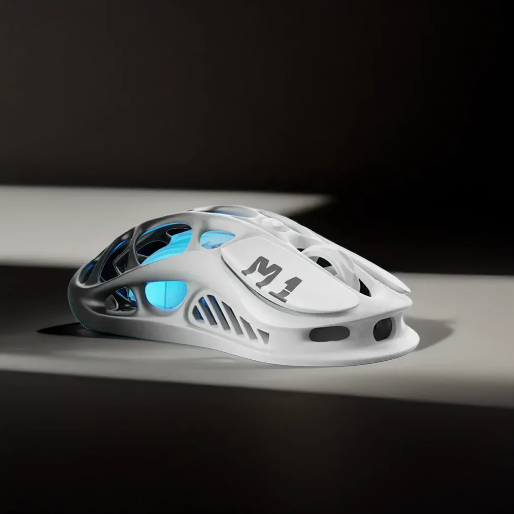 GravaStar Pro Gaming Set Gradient White Mercury M1 Pro wireless gaming mouse side view featuring magnesium alloy skeletal frame, M1 logo, anti-slip side grips, and ice blue RGB backlighting.
