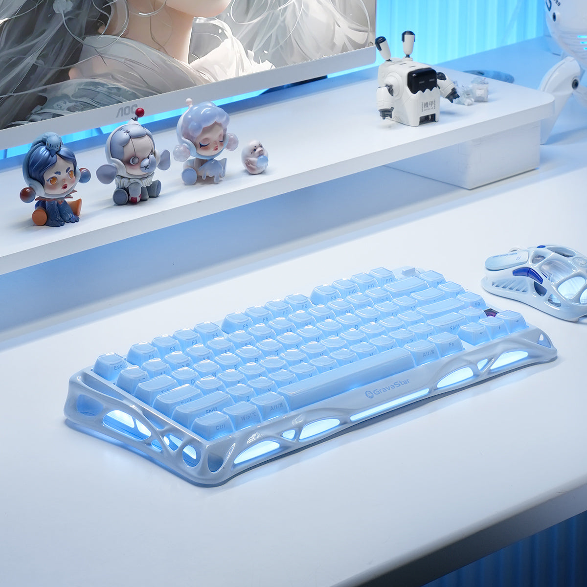 GravaStar Pro Gaming Set Ice Blue desktop setup perspective view showing Mercury K1 Special Edition keyboard with ice blue backlighting, Mercury M1 Pro magnesium mouse, and anime desk figures in a clean futuristic setup.