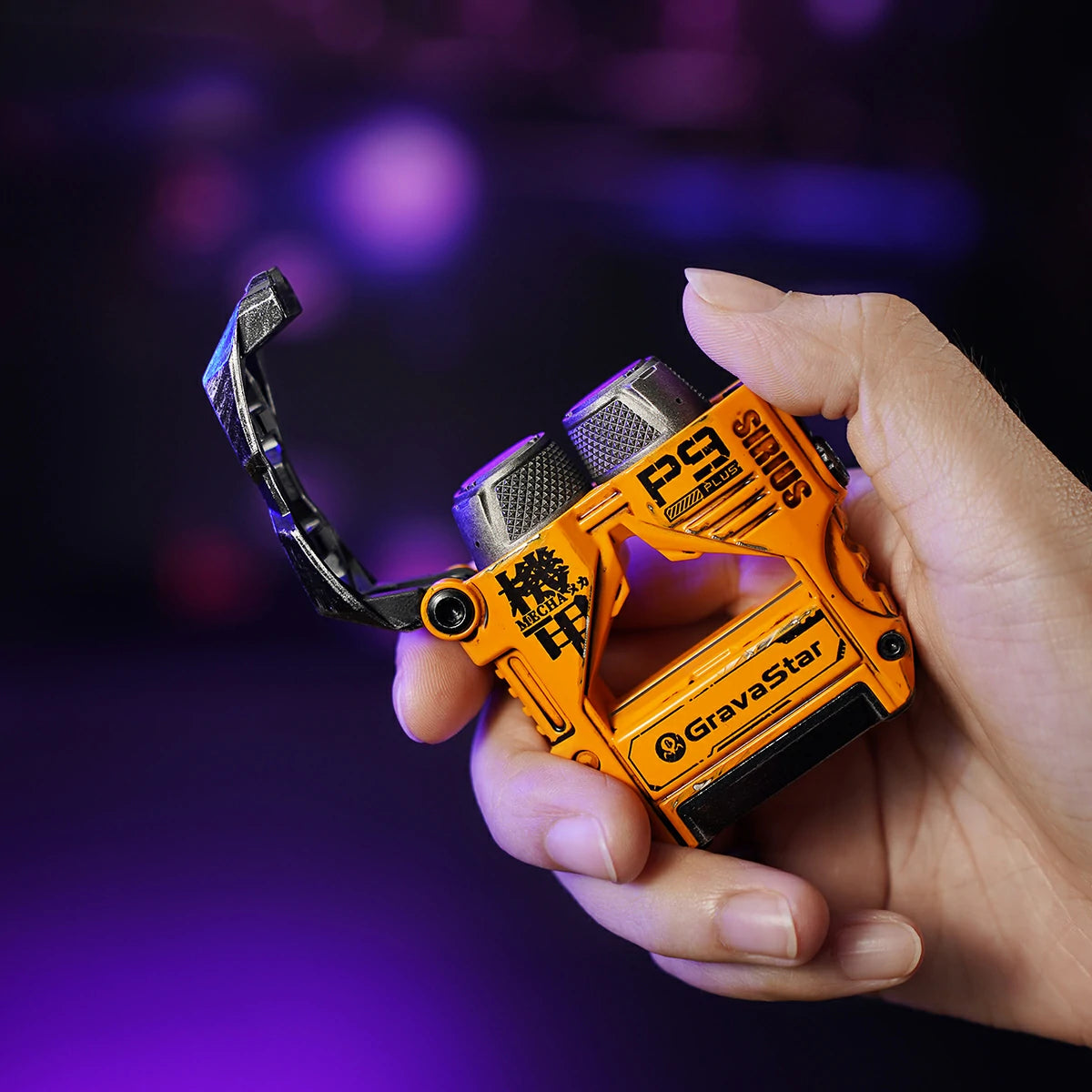 GravaStar Sirius Plus Special Edition War-Damaged Yellow wireless ANC earbuds set on desert background displaying handcrafted weathered yellow zinc aluminium alloy mecha charging case with bottle opener design, dual earbuds, 10mm dynamic drivers, and RGB lighting.