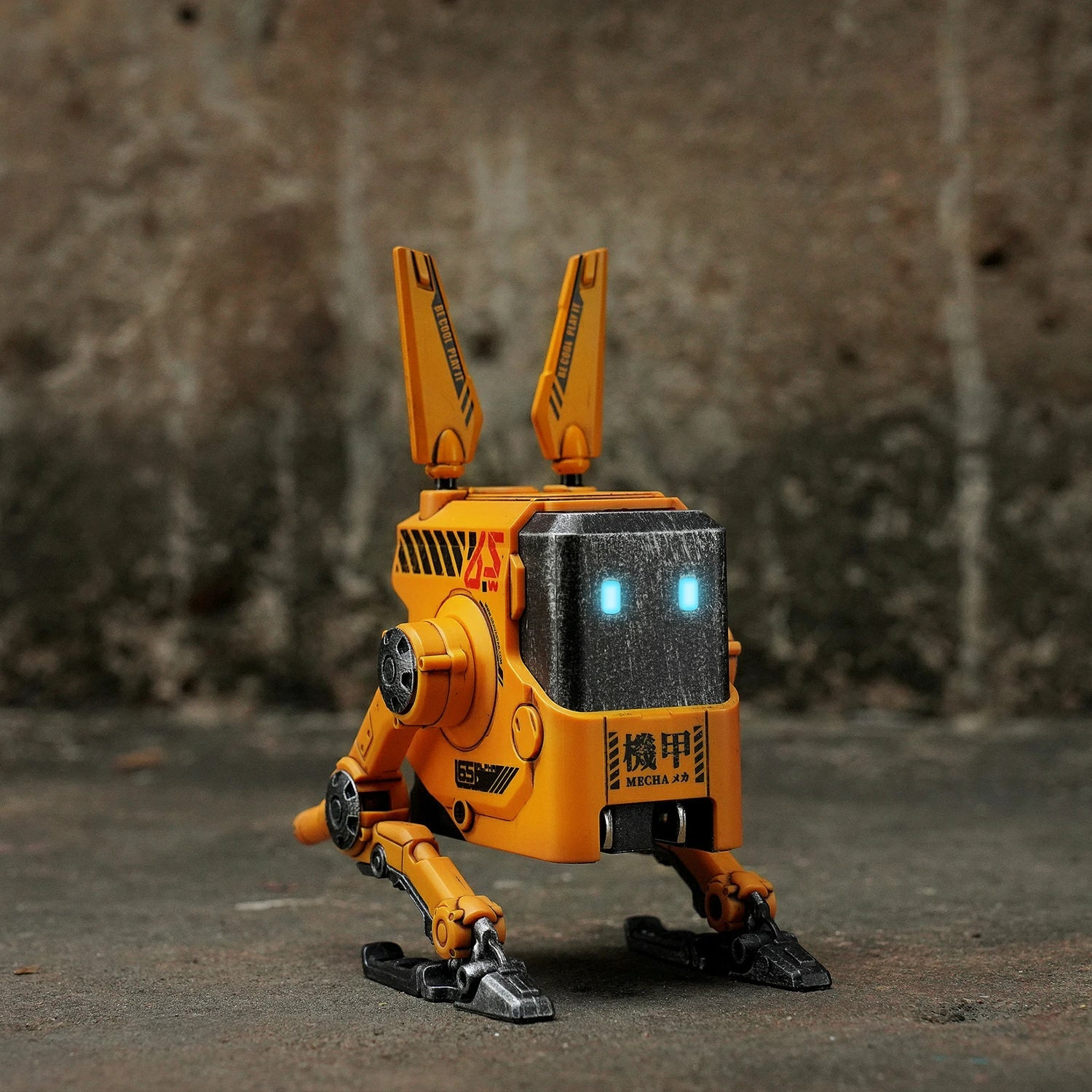 GravaStar Alpha65 War-Damaged Yellow handcrafted 65W GaN fast charger studio robot standing view featuring authentic weathered yellow finish, transformable tripod stand, dual antennas, ice blue RGB eyes, and 3 USB ports, perfect paired with Mercury X Pro Yellow mouse and Mercury K1 Pro Yellow keyboard.