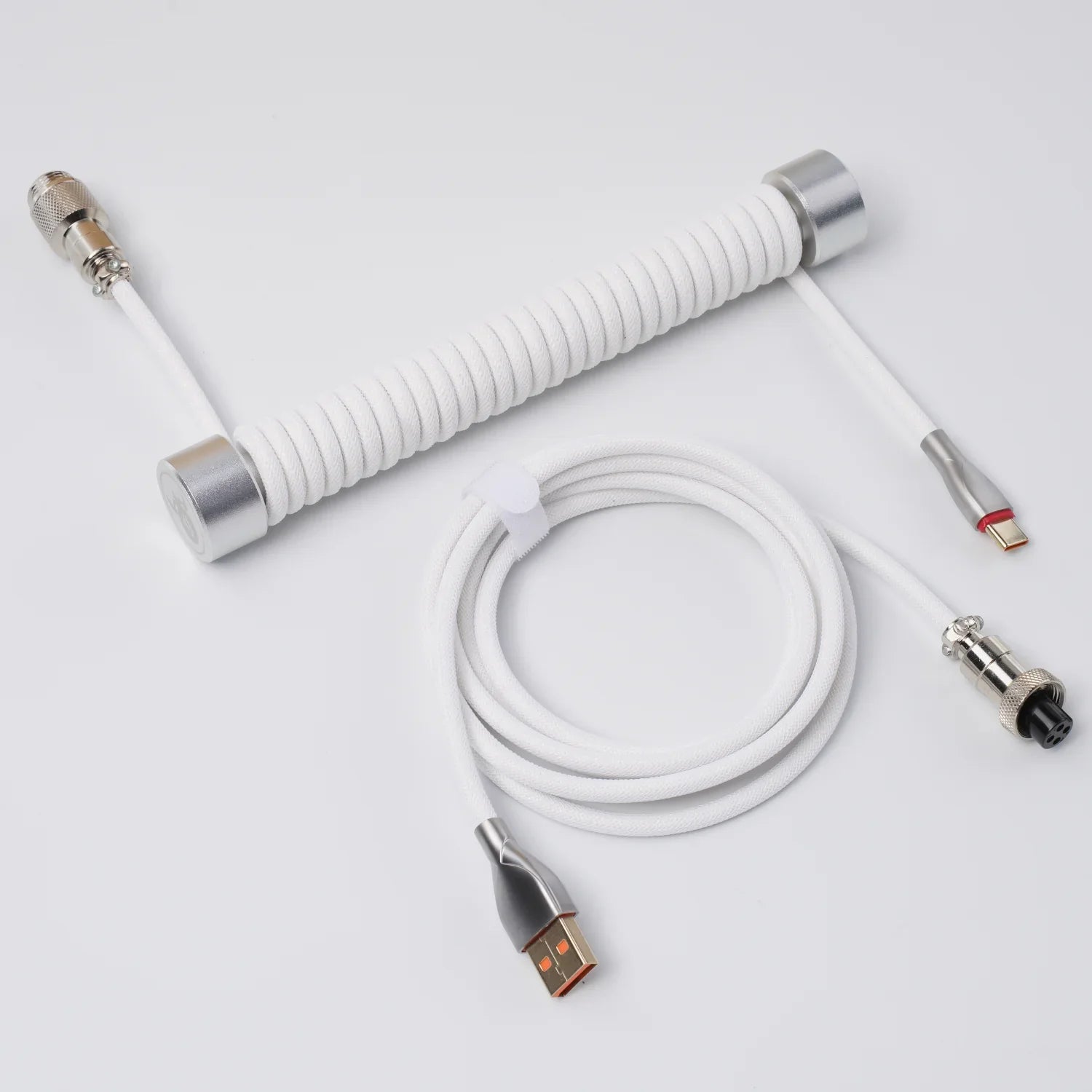 GravaStar Coiled Aviator USB Cable in white studio full component view showing 4-pin detachable aviator connector, TPU EVA double-sleeved braided cable body, gold-plated USB-A to Type-C terminals, perfect paired with Mercury K1 Pro keyboard and GravaStar Gaming Mouse Pad deskmat.