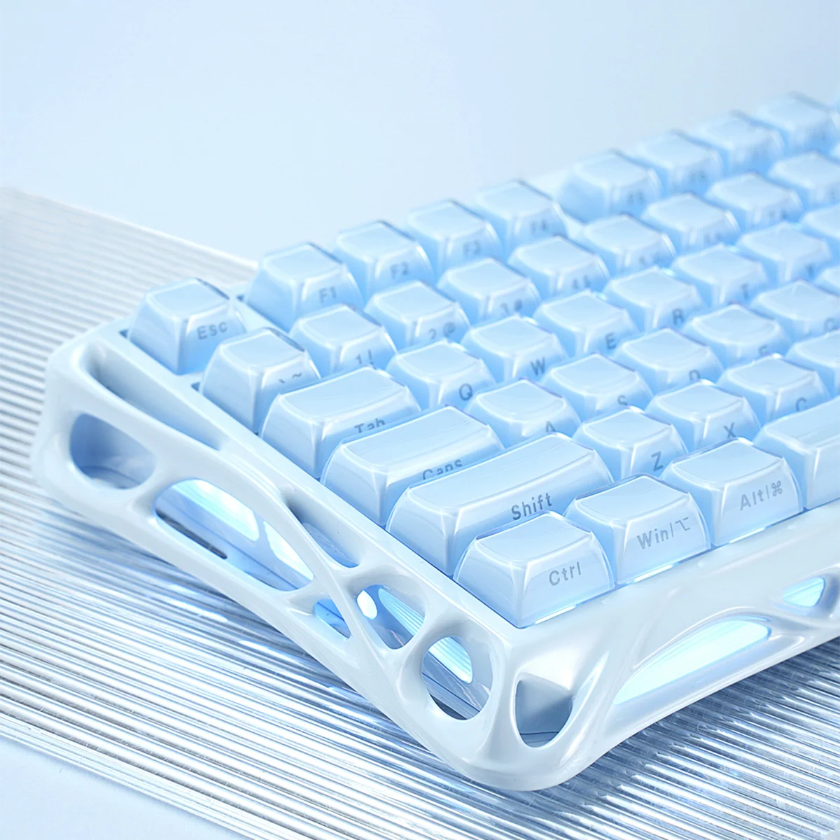 GravaStar Mercury K1 Ice Blue Edition 75% mechanical gaming keyboard side view – Highlighting ice blue aluminum skeleton frame, translucent white keycaps, custom linear switches, and dynamic RGB backlighting.