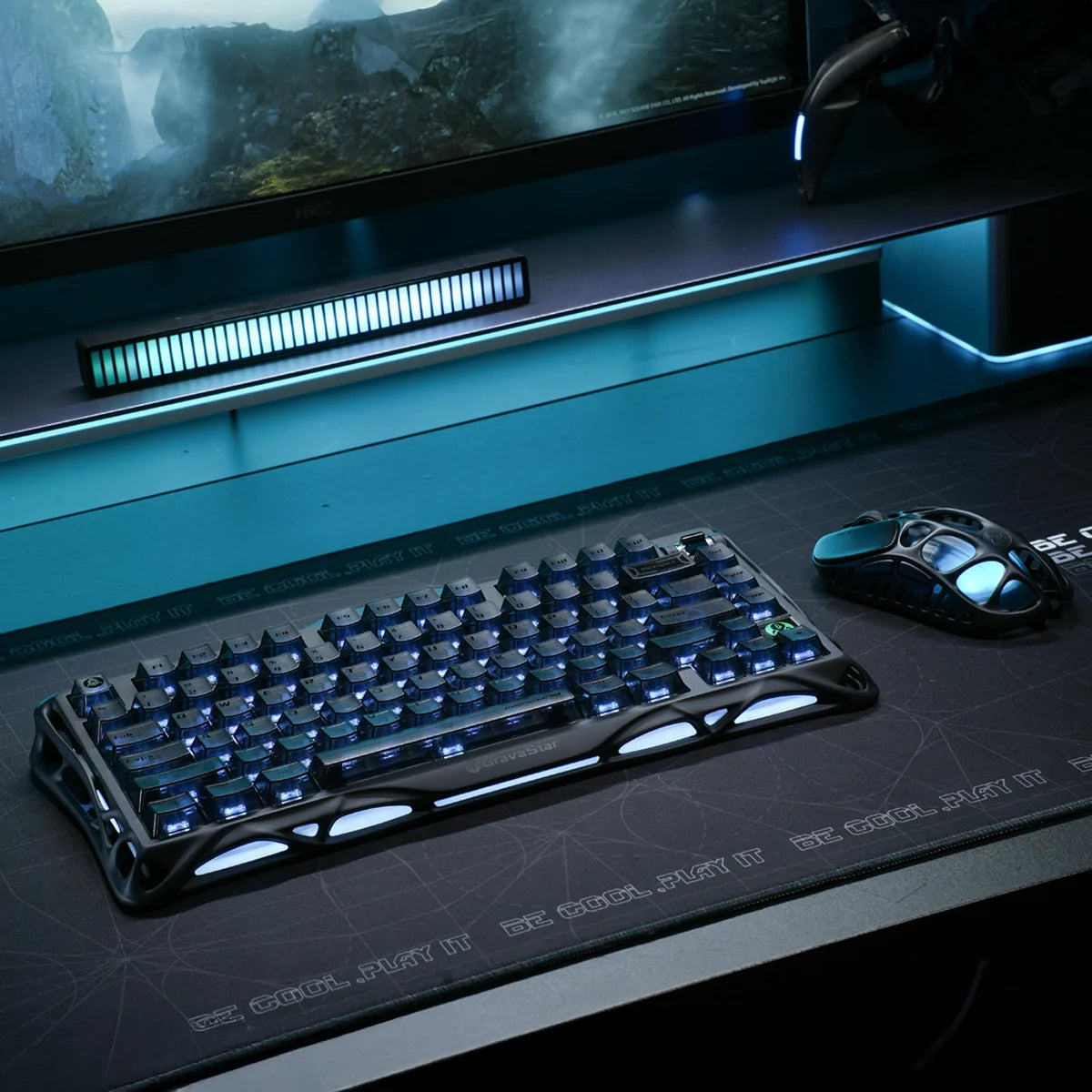 GravaStar Mercury K1 Stealth Black 75% mechanical gaming keyboard on dark desk setup, paired with GravaStar M2 Stealth Black wireless mouse, featuring custom Stellar Bloom linear switches and dual RGB lighting.