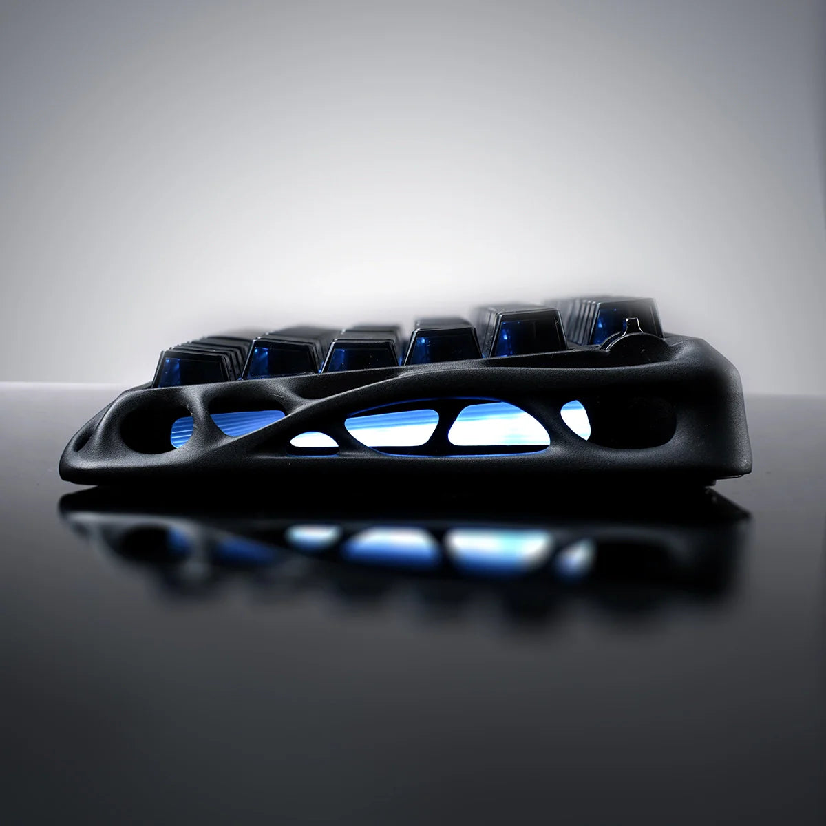 GravaStar Mercury K1 Stealth Black 75% gaming keyboard side profile view – Highlighting hollowed aluminum alloy chassis, 5-layer PORON sound dampening, and dual RGB lighting, perfect paired with GravaStar M2 Stealth Black mouse.