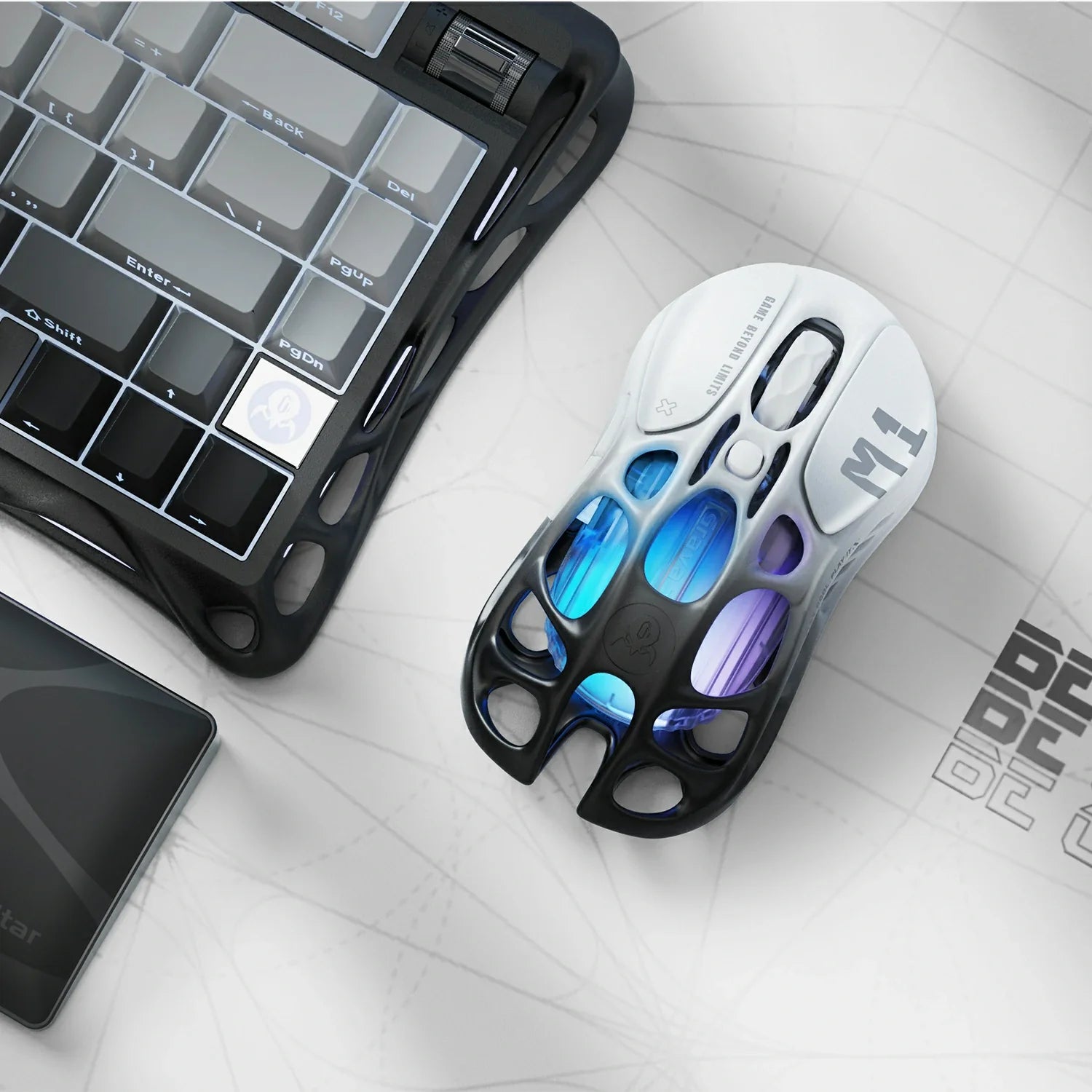 GravaStar Mercury M1 Pro Gradient Black wireless gaming mouse top view on desk setup with Mercury K1 Pro keyboard – Highlighting magnesium alloy skeletal frame, PAW3395 26K DPI sensor, Omron 50M micro-switches, 4KHz polling rate ready, and blue-purple RGB lighting.