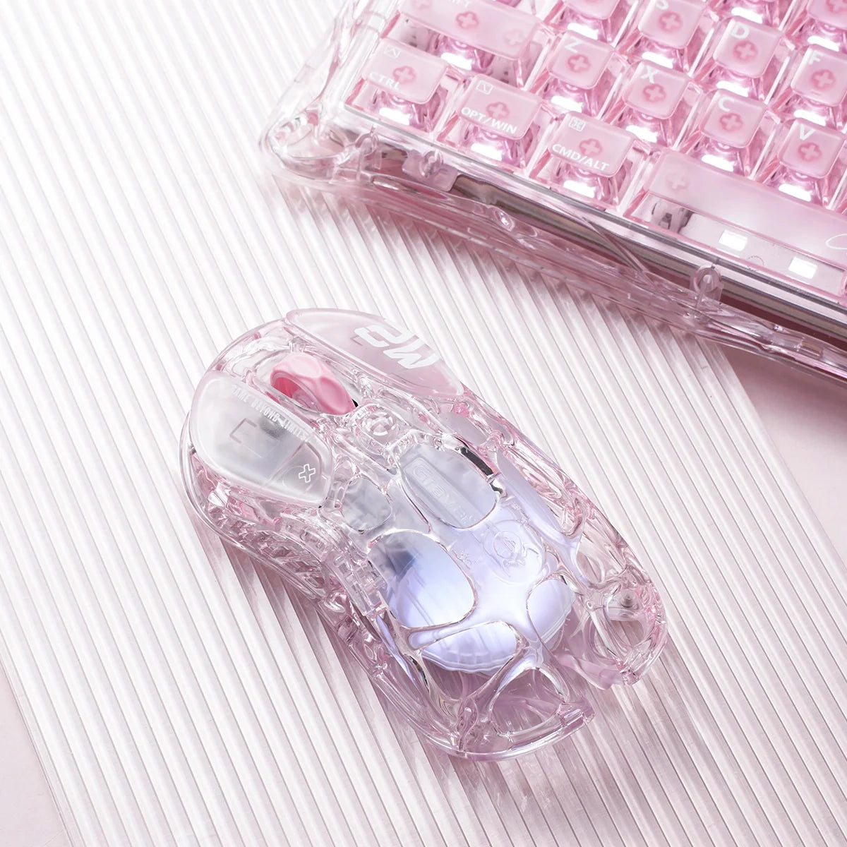 GravaStar Mercury M2 Crystal Rose 2024 Red Dot Award winner translucent wireless gaming mouse macro setup angled view paired with Mercury V60 Crystal Rose keyboard, featuring 88g skeletal frame, PAW3395 26K DPI sensor, 1000Hz polling rate, and RGB lighting.