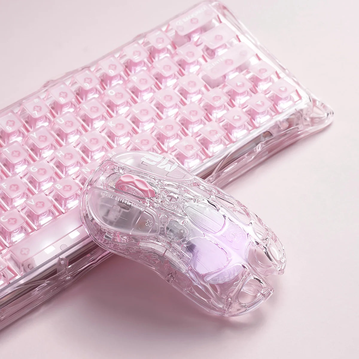 GravaStar Mercury M2 Crystal Rose 2024 Red Dot Award winner translucent wireless gaming mouse macro setup vertical view paired with Mercury V60 Crystal Rose keyboard, featuring 88g skeletal frame, PAW3395 26K DPI sensor, 1000Hz polling rate, and RGB lighting.