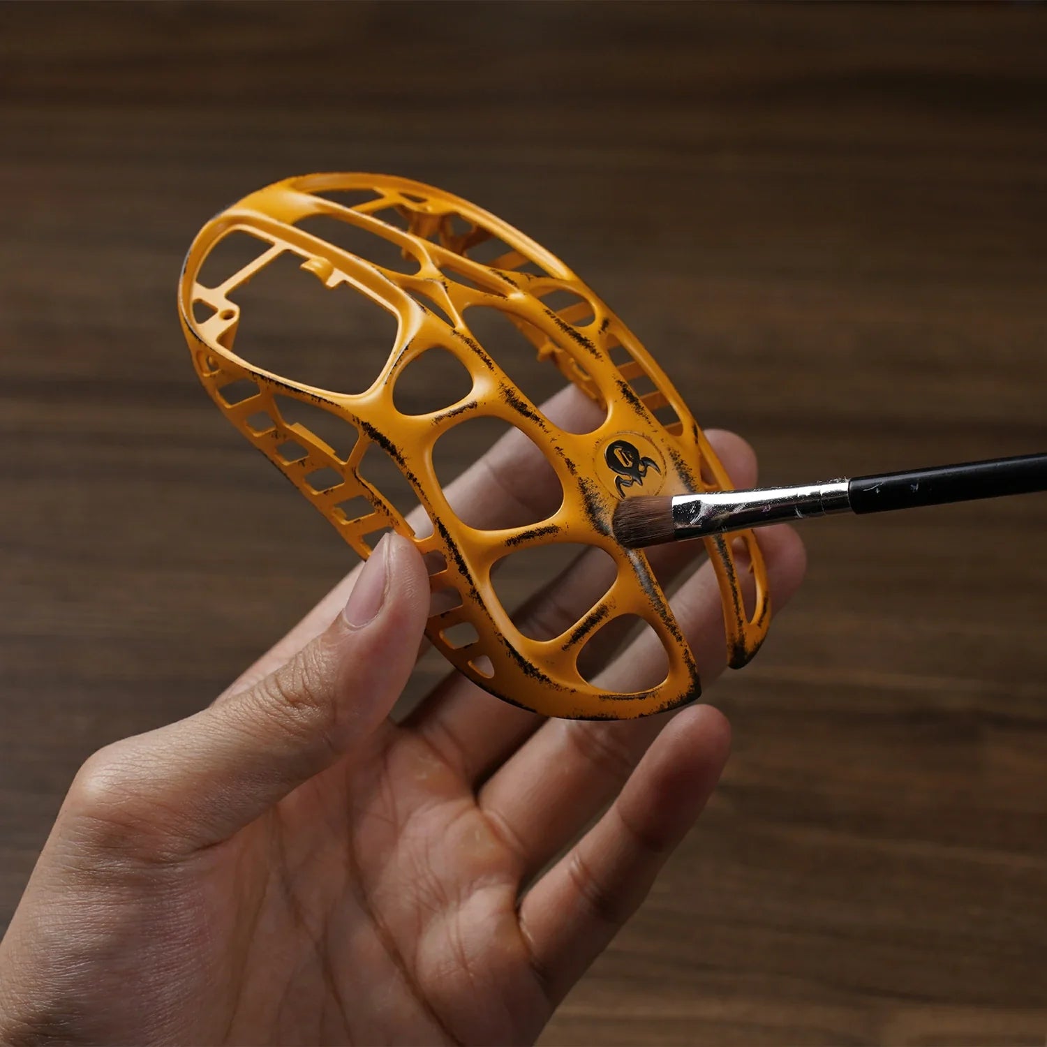 Artisan hand-applying battle-worn weathering and finish to the GravaStar Mercury X Pro Special Edition Battle Worn-Yellow magnesium alloy skeleton, featuring PAW 3950 sensor, 8000Hz polling rate, and 49g ultra-lightweight design, perfect paired with Mercury K1 Pro Yellow keyboard and Mars Pro Yellow speaker.