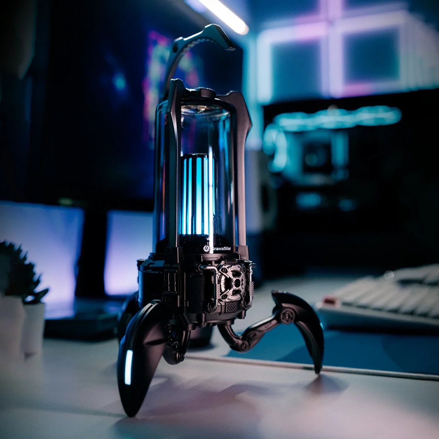 GravaStar Supernova Matt Black mecha-lantern Bluetooth speaker setup angled view featuring 25W dual-driver sound system, 3" woofer, 0.5" tweeter, zinc alloy frame, foldable tripod stand, carry handle, and vibrant RGB lighting, perfect paired with Mercury X Air Onyx Crystal mouse and Mercury V60 keyboard.