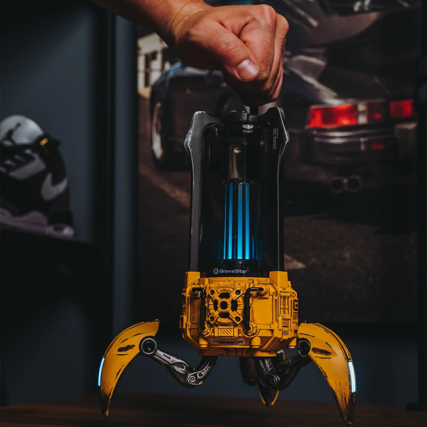 GravaStar Supernova War Damaged Yellow handcrafted mecha-lantern Bluetooth speaker angled macro view featuring 25W dual-driver sound system, 3" woofer, 0.5" tweeter, zinc alloy frame, foldable tripod stand, carry handle, and vibrant RGB lighting, perfect paired with Mercury X Pro Yellow mouse and Mercury K1 Pro Yellow keyboard.